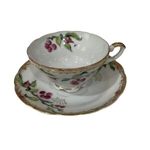 Ucago Teacup and Saucer, gold trim with cherries and greenery.